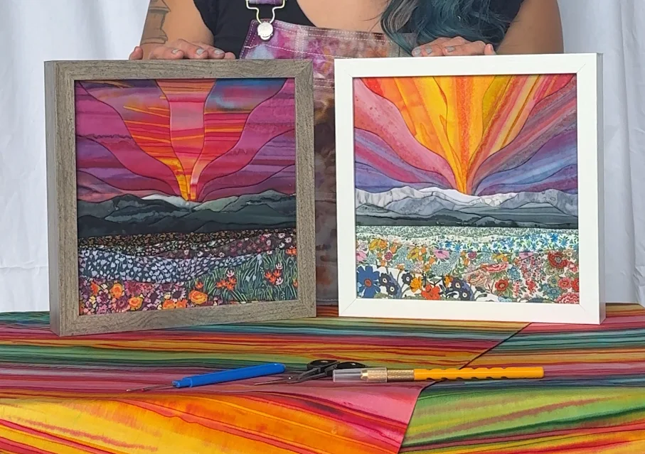 Two finished kinusaiga fabric landscapes in different colorways, displayed with the tools that made them